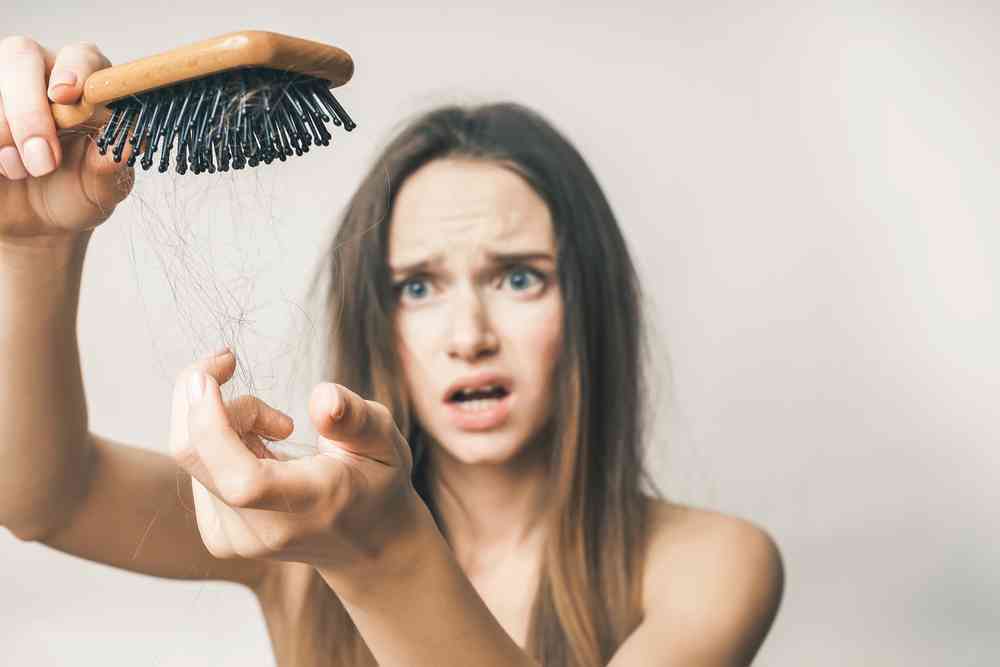 hair loss after pregnancy - brush with hair